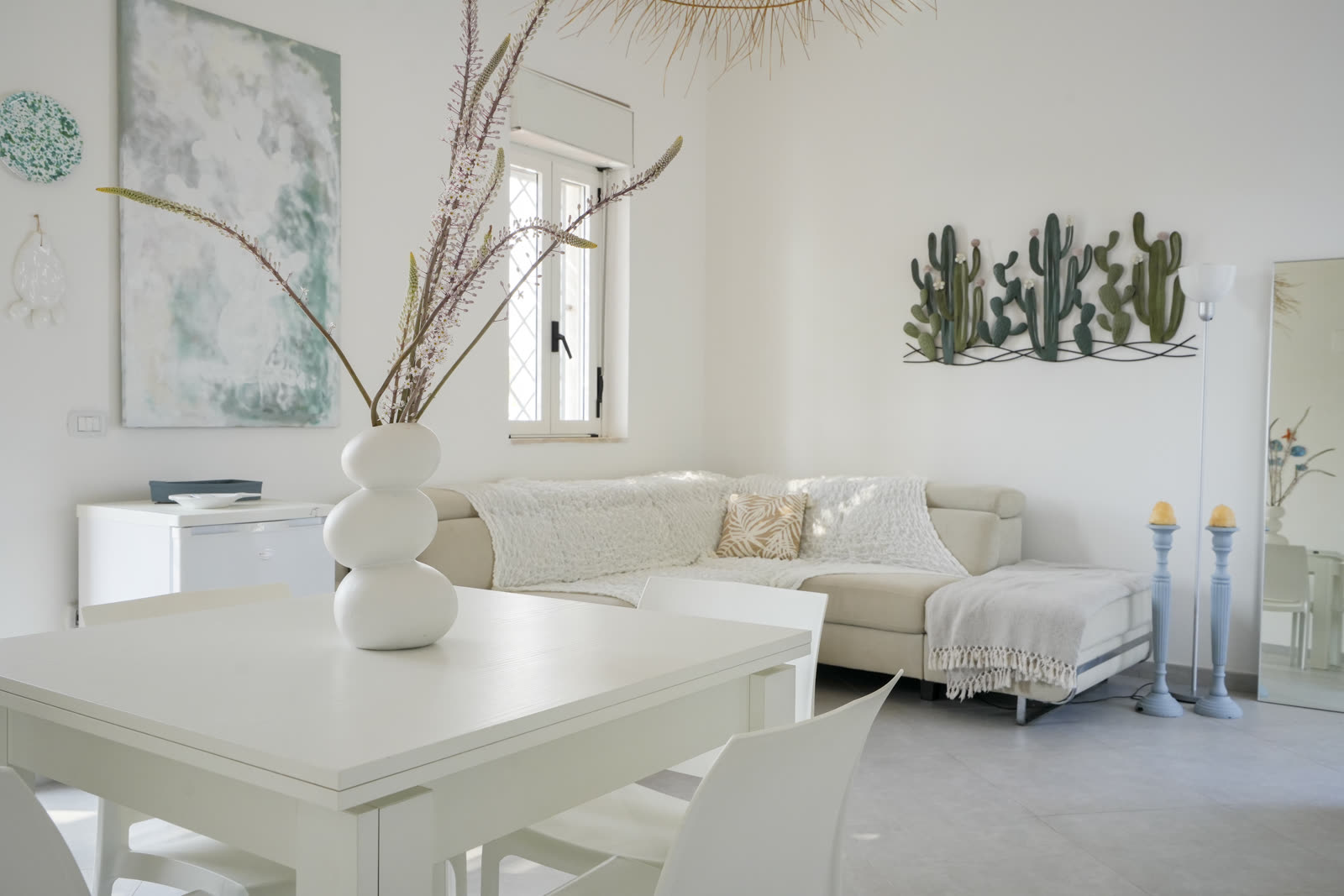 Lounge with vase and cactus wall art