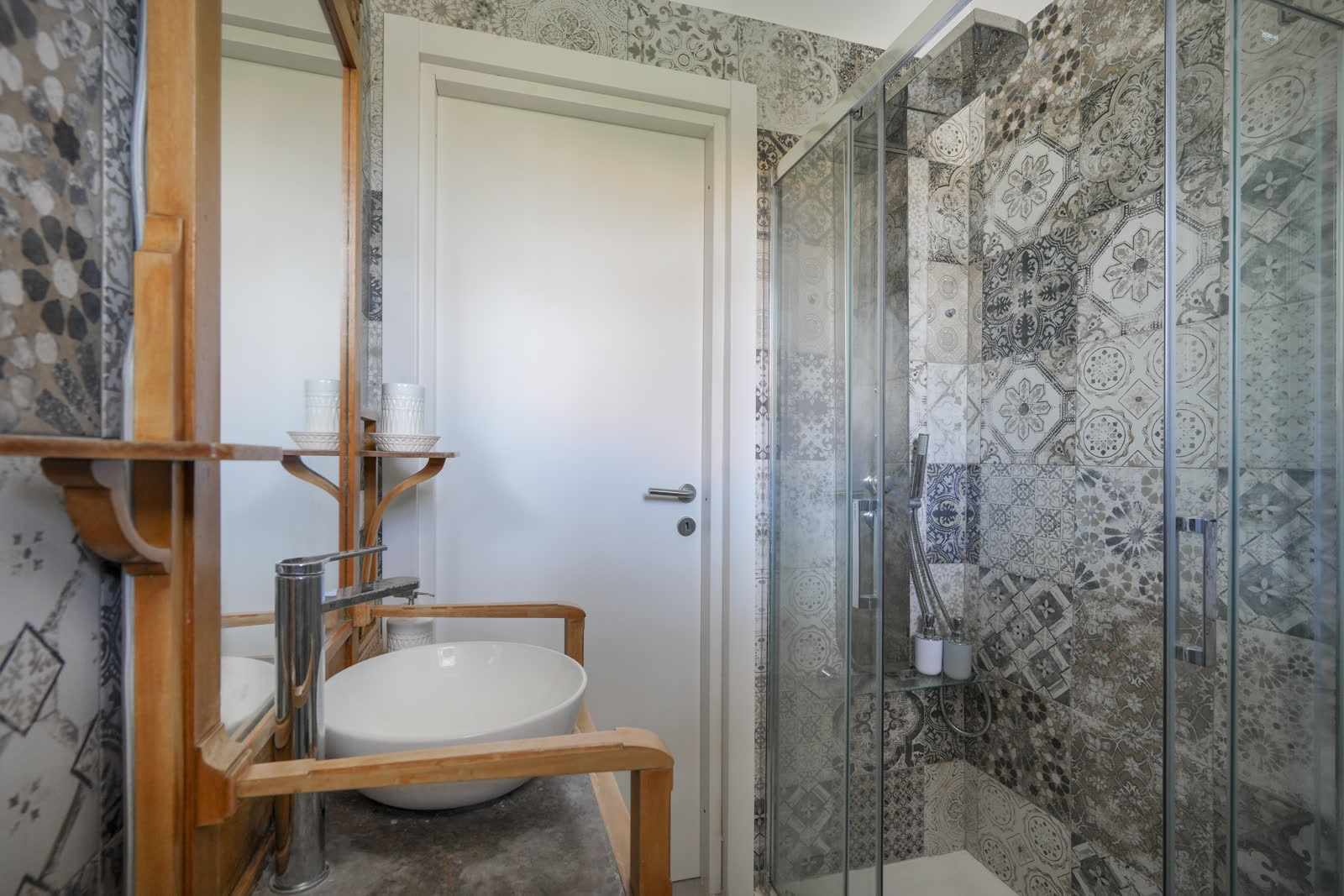 Bathroom with patterned tile shower